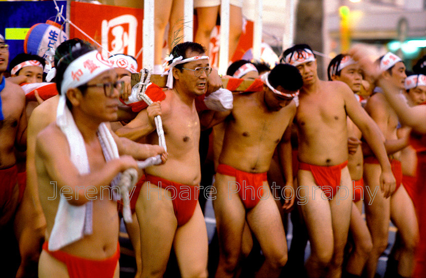 Travel-J5706-Guys-in-pants 
 Men carrying a portable shrine (mikoshi), Uwajima, Japan